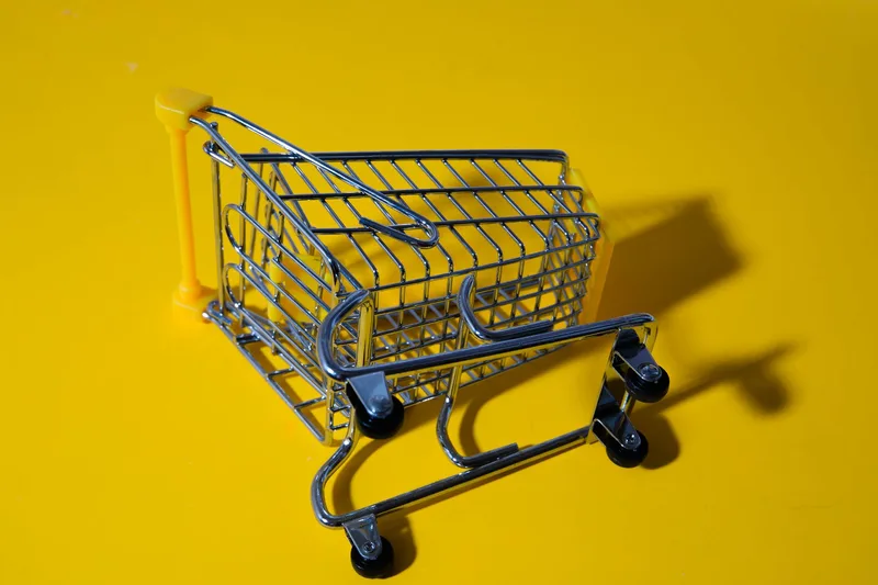 Side-by-side comparison of a Shopify cart page before and after adding a native Liquid upsell widget showing the added offer block